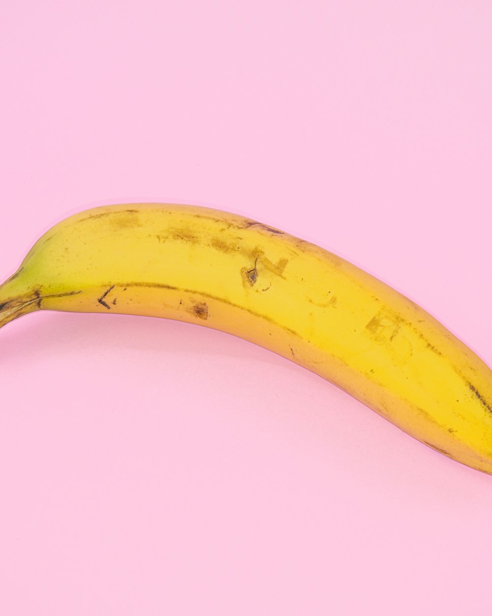 A banana on a pink background