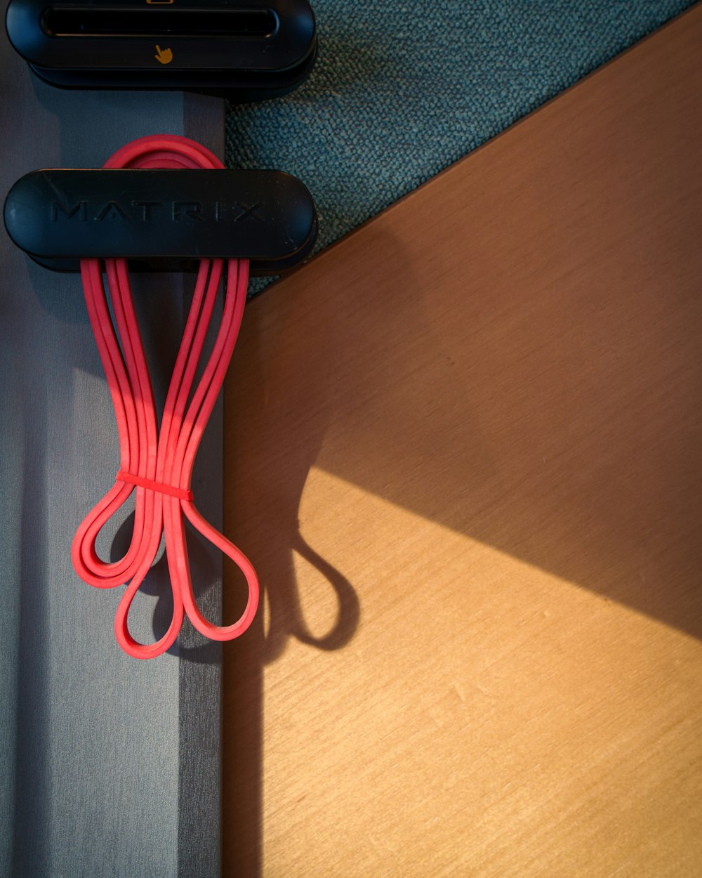 A pink resistance band hanging in warm light