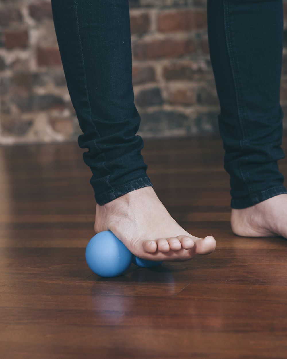 A foot rolling on a massage ball