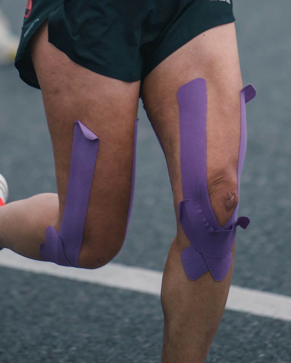 Kinesiology tape on a runner's knees